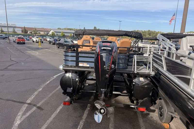 Slide: The Image of 2026 Ranger 220F pontoon boat with Mercury outboard motor in a parking lot. - 4