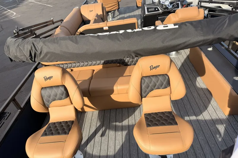 Slide: The Image of 2026 Ranger 220F boat interior with tan leather seats and modern design. - 11