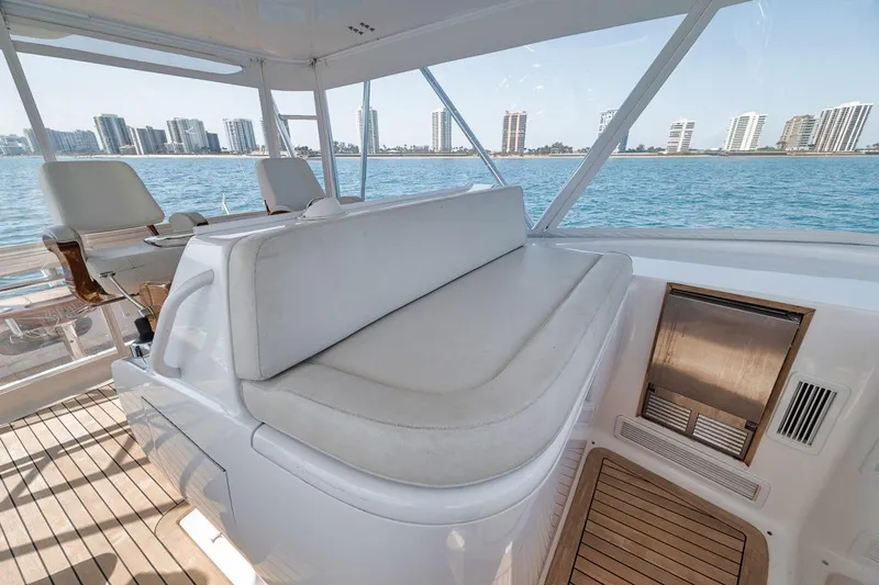 Slide: The Image of 2012 Spencer Yachts Express interior with seating, overlooking waterfront cityscape. - 14
