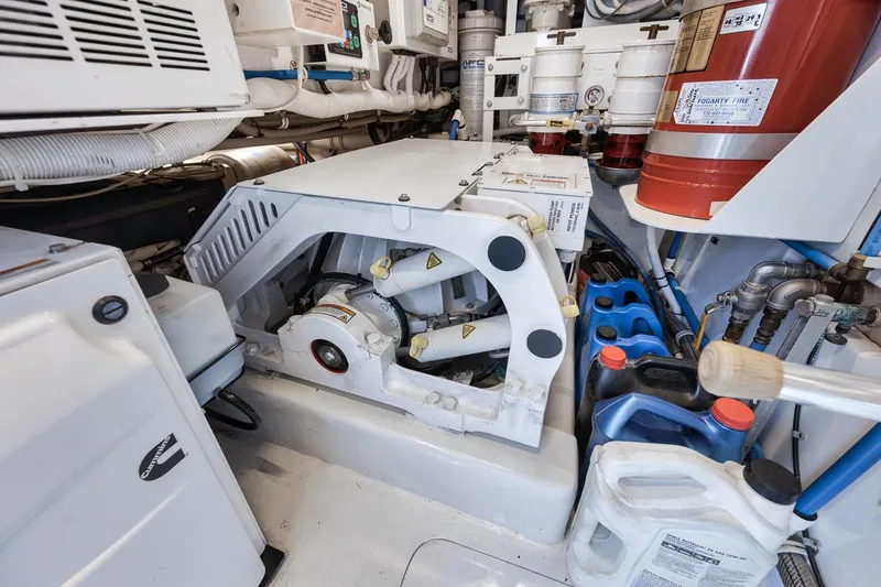 Slide: The Image of Engine room of 2012 Spencer Yachts Express, featuring mechanical components and storage containers. - 17
