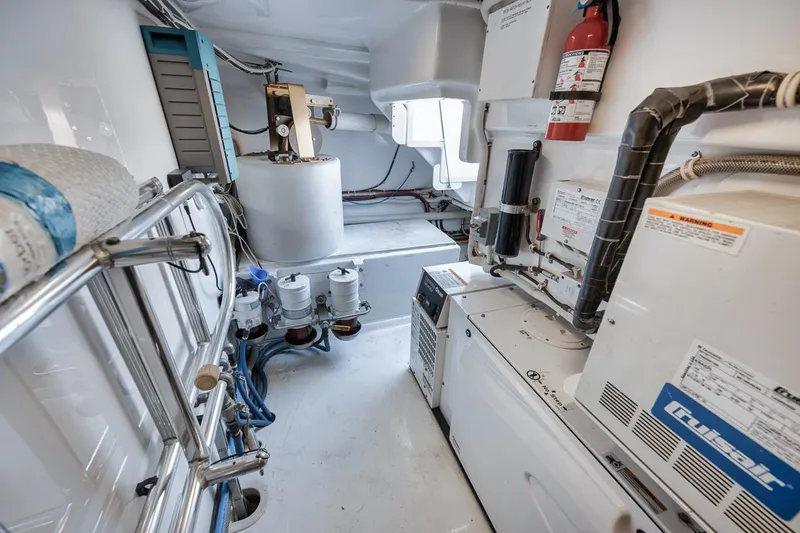 Slide: The Image of Engine room of 2012 Spencer Yachts Express, featuring equipment and storage. - 18