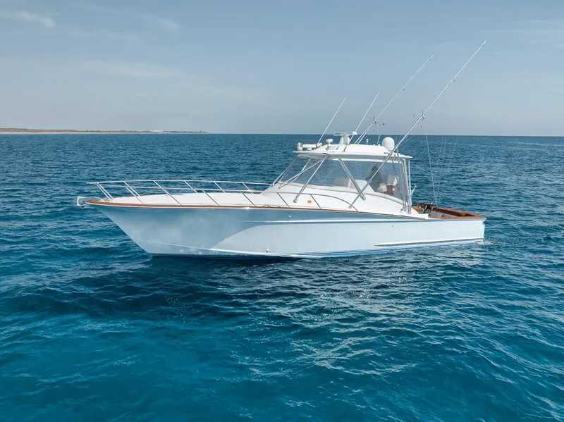 Slide: The Image of 2012 Spencer Yachts Express boat on clear blue water, aerial view. - 2