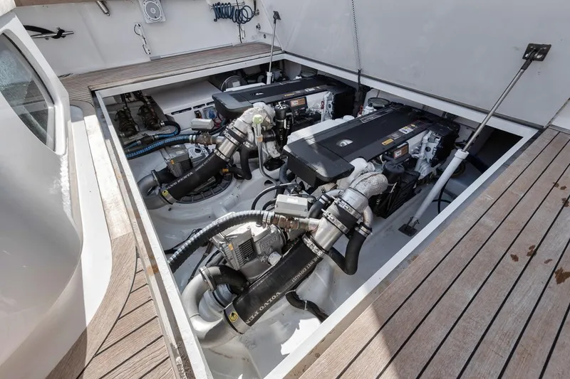 Slide: The Image of Engine room of 2012 Spencer Yachts Express, showcasing dual engines and wooden deck. - 21