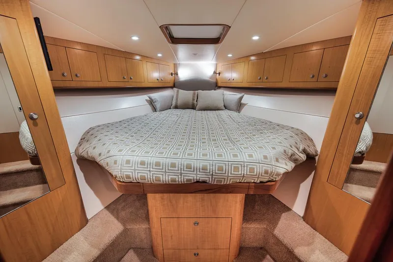 Slide: The Image of Luxurious cabin interior of 2012 Spencer Yachts Express with cozy bed and wooden cabinetry. - 31