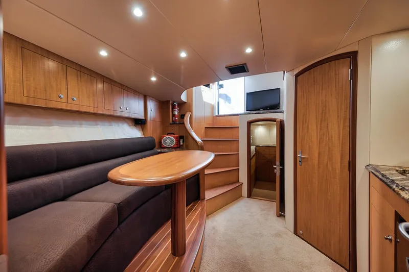 Slide: The Image of 2012 Spencer Yachts Express kitchen with wood cabinets, granite countertop, microwave, and dishwasher. - 33