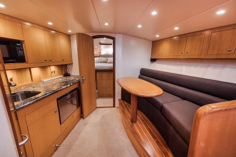 Slide: The Image of 2012 Spencer Yachts Express kitchen with wood cabinetry and stainless steel appliances. - 36