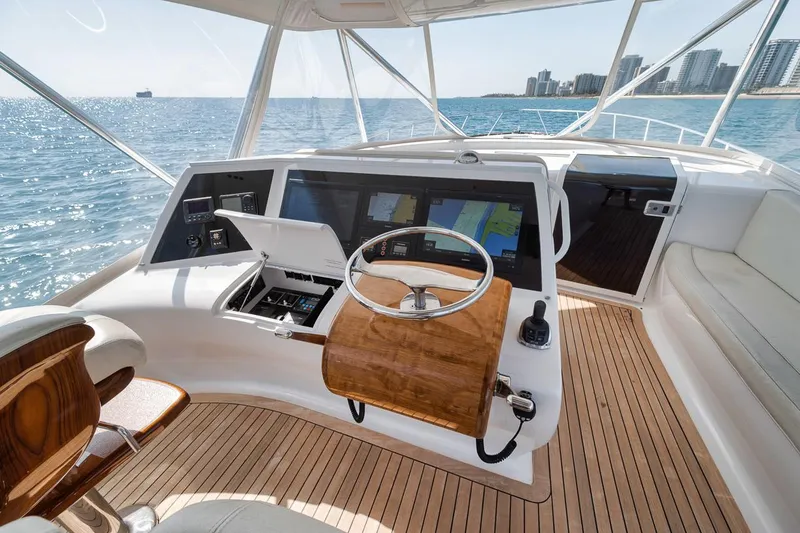 Slide: The Image of 2012 Spencer Yachts Express helm with ocean view and city skyline in the background. - 44