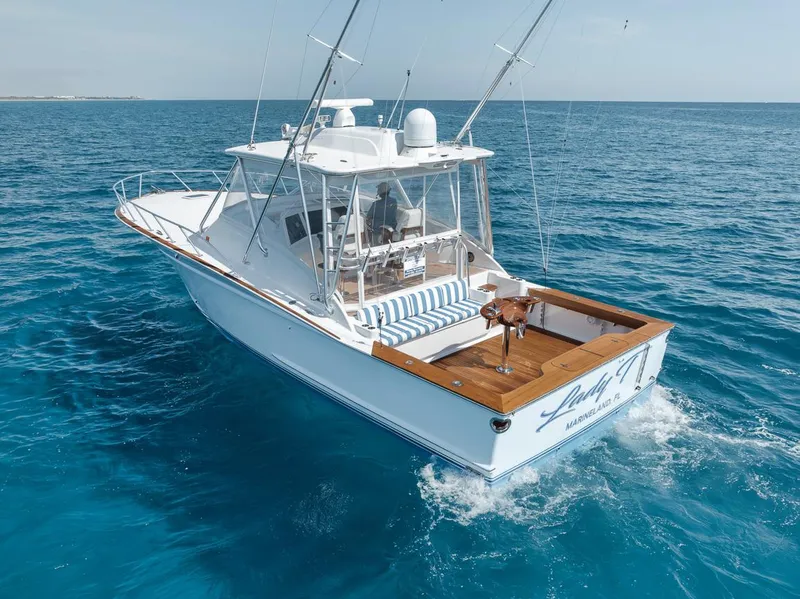 Slide: The Image of 2012 Spencer Yachts Express boat cruising on clear blue ocean waters. - 6