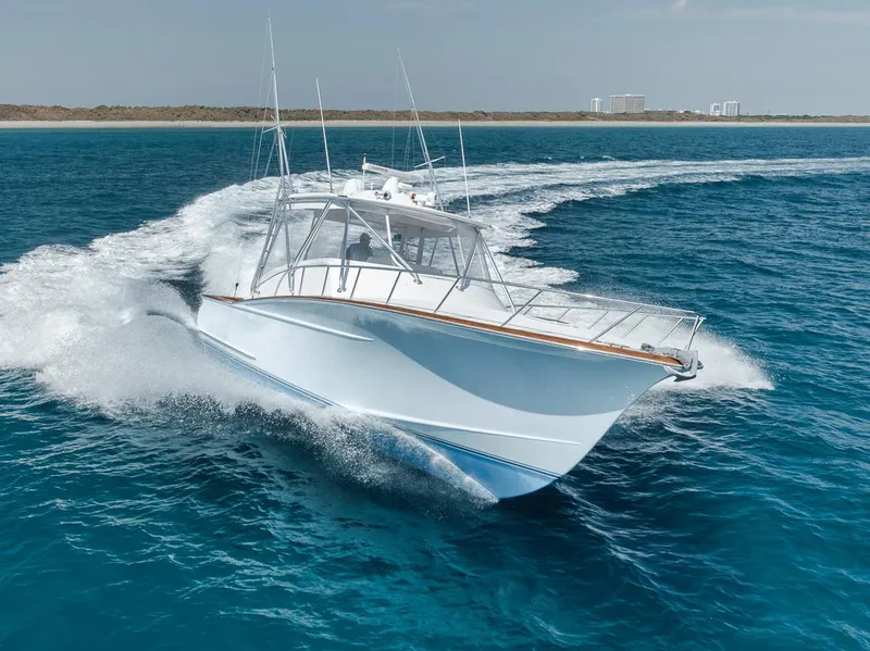 Slide: The Image of 2012 Spencer Yachts Express cruising on clear blue ocean waters. - 11