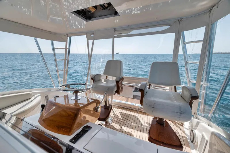 Slide: The Image of 2012 Spencer Yachts Express interior with ocean view, featuring luxurious seating and wooden accents. - 12