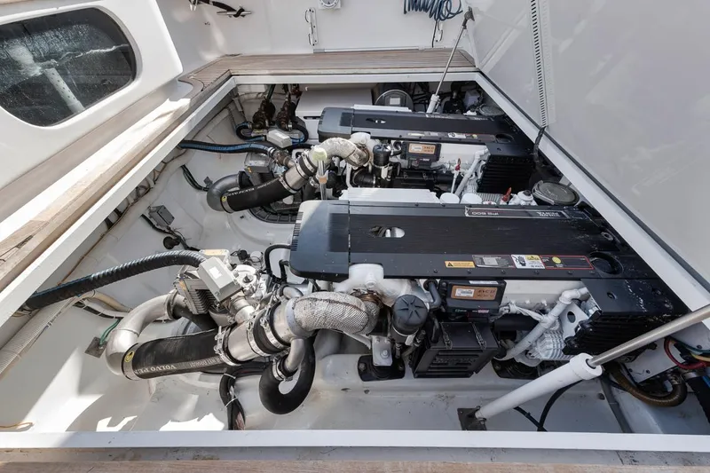 Slide: The Image of Engine compartment of a 2012 Spencer Yachts Express, showcasing dual engines and mechanical components. - 22