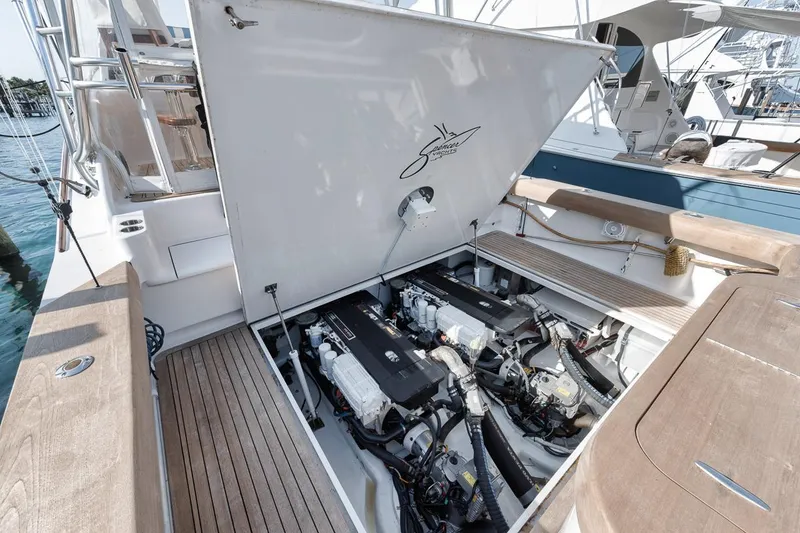 Slide: The Image of 2012 Spencer Yachts Express engine compartment with twin engines, open hatch, and teak decking. - 24
