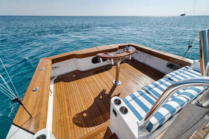 Slide: The Image of 2012 Spencer Yachts Express deck with ocean view, featuring wooden flooring and striped seating. - 39