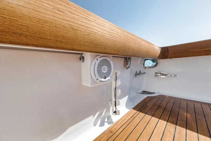 Slide: The Image of 2012 Spencer Yachts Express deck with wood finish and speaker. - 42