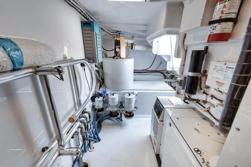 Slide: The Image of Engine room of 2012 Spencer Yachts Express, featuring equipment and piping. - 19