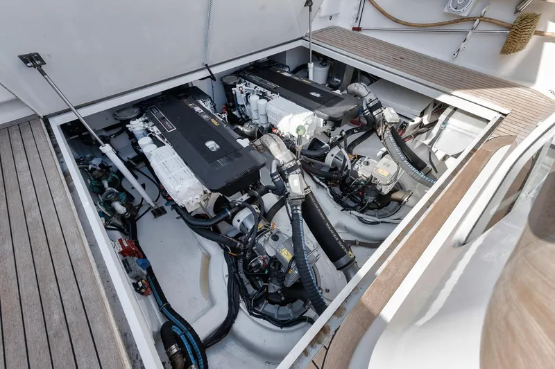 Slide: The Image of Engine room of 2012 Spencer Yachts Express, showcasing dual engines and mechanical components. - 23