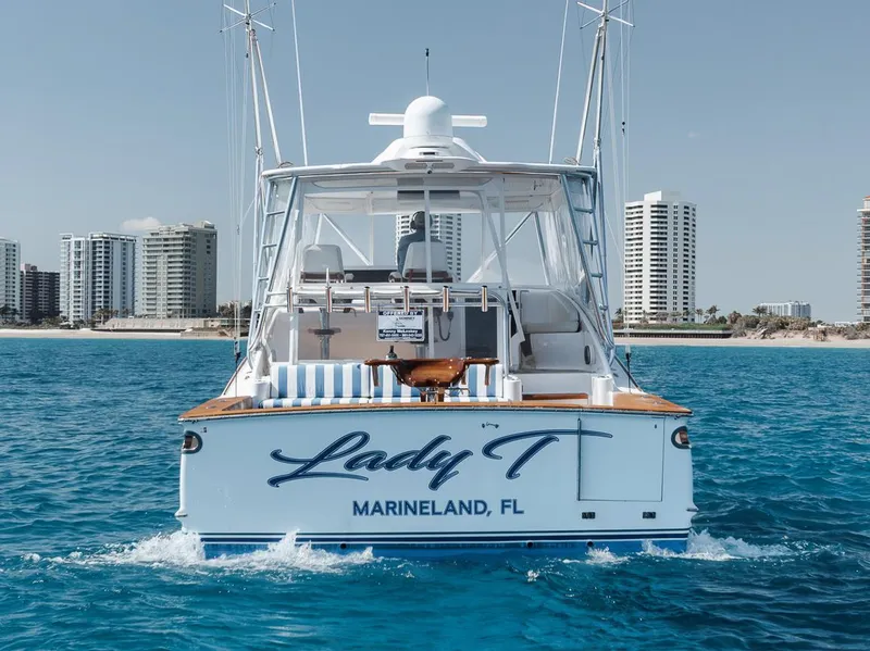 Slide: The Image of 2012 Spencer Yachts Express boat on blue water, city skyline in background. - 3