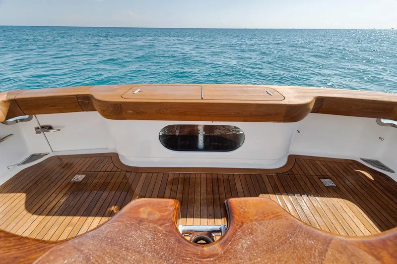 Slide: The Image of 2012 Spencer Yachts Express boat deck with wooden finish, overlooking the ocean. - 41