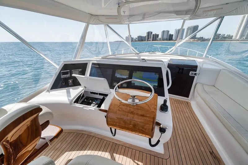 Slide: The Image of 2012 Spencer Yachts Express helm with ocean view and city skyline in the background. - 46