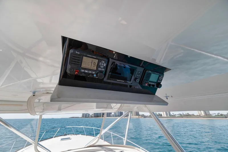 Slide: The Image of 2012 Spencer Yachts Express helm with navigation equipment, overlooking ocean and distant cityscape. - 49