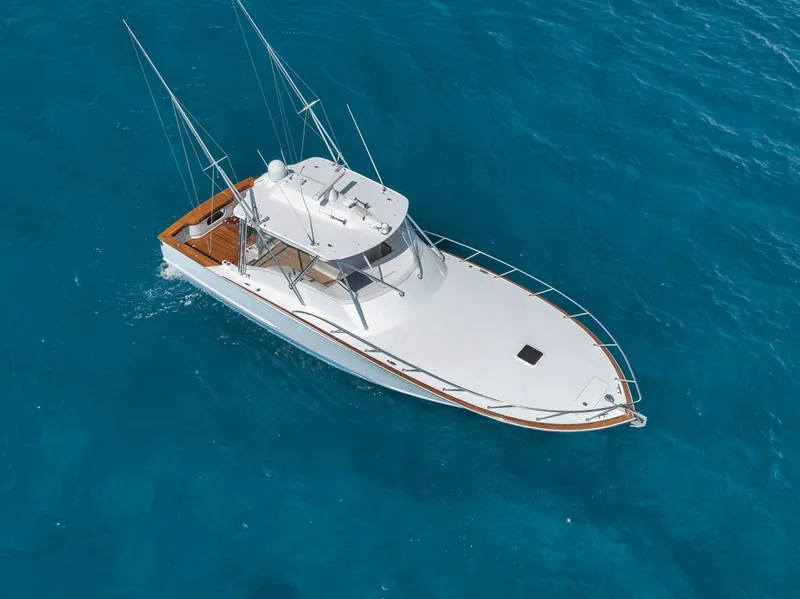 Slide: The Image of 2012 Spencer Yachts Express cruising on clear blue water. - 7