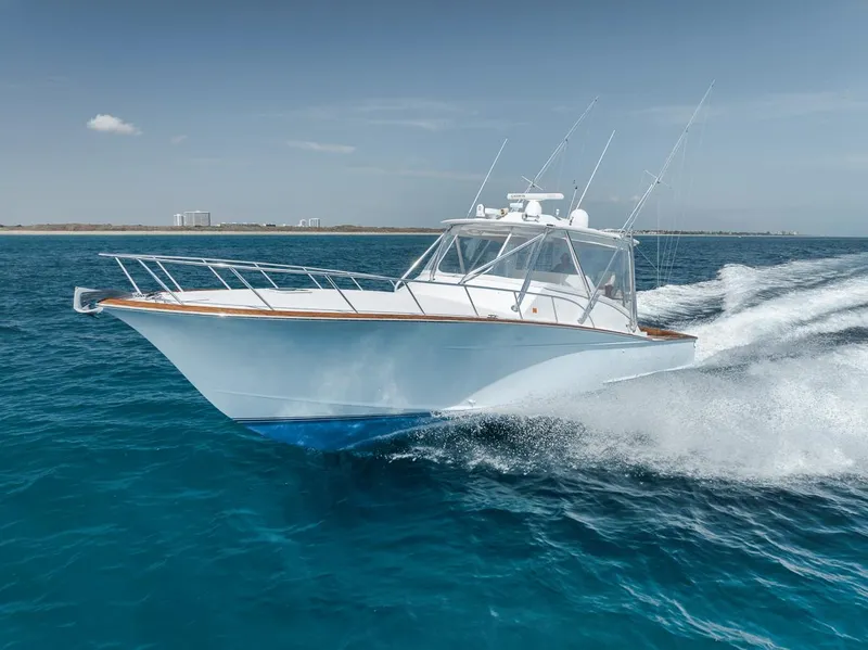 Slide: The Image of 2012 Spencer Yachts Express cruising on clear blue ocean waters. - 9