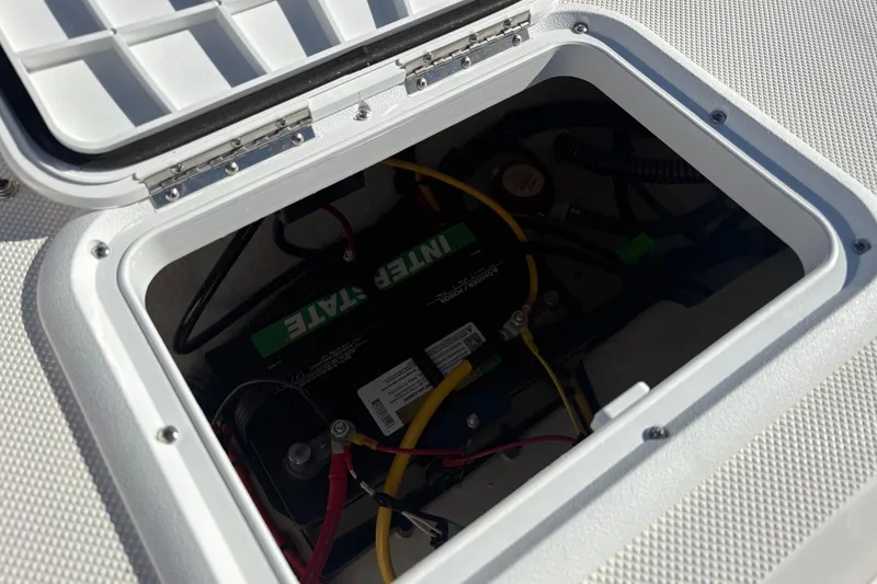 Slide: The Image of Battery compartment of 2026 Sundance B20CCR boat with visible wiring and connections. - 14