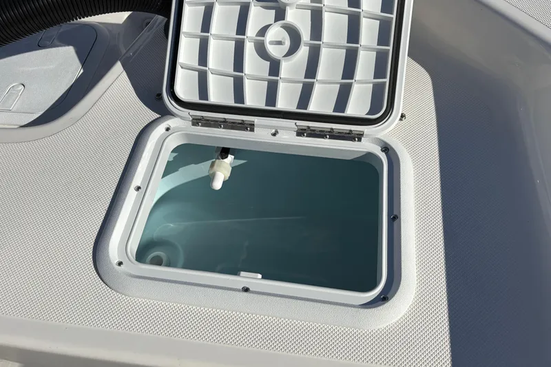 Slide: The Image of Open hatch on 2026 Sundance B20CCR boat, showing interior compartment. - 15