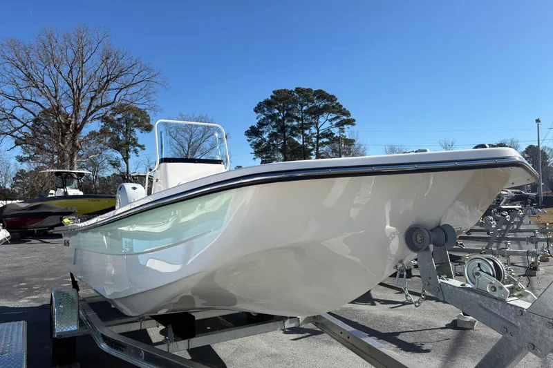 Slide: The Image of 2026 Sundance B20CCR boat on trailer under clear blue sky. - 2