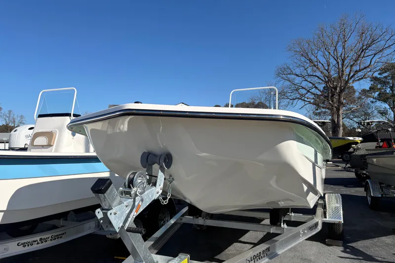Slide: The Image of 2026 Sundance B20CCR boat on trailer under clear blue sky. - 3