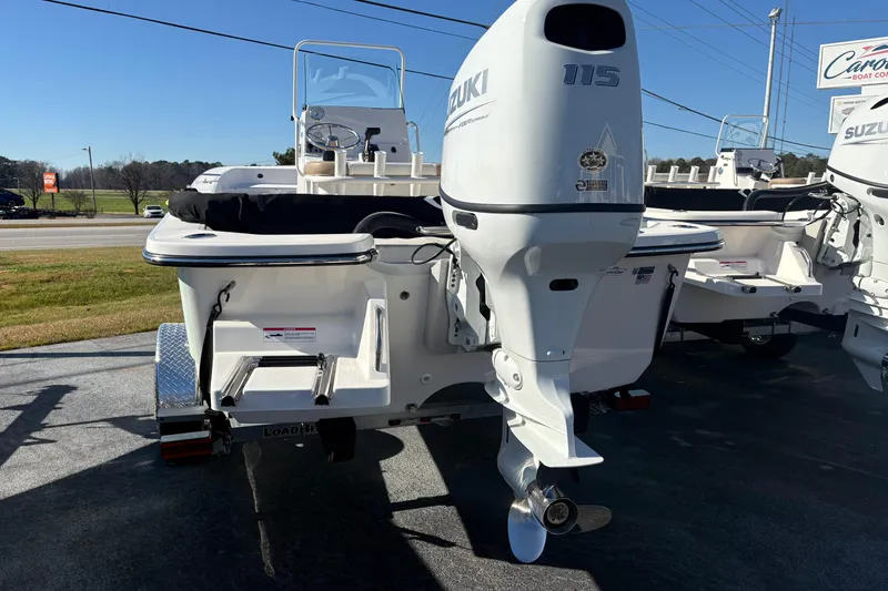 Slide: The Image of 2026 Sundance B20CCR boat with Suzuki 115 outboard motor displayed outdoors. - 4