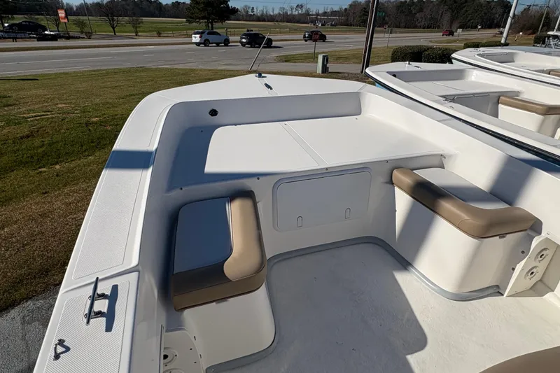 Slide: The Image of 2026 Sundance B20CCR boat interior with cushioned seating and storage compartments. - 5