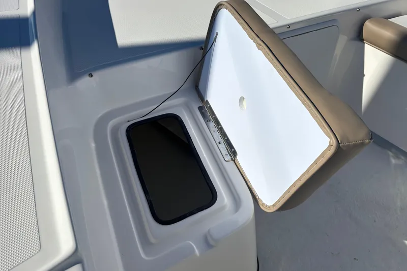 Slide: The Image of 2026 Sundance B20CCR boat storage compartment with open lid, showcasing interior design. - 6