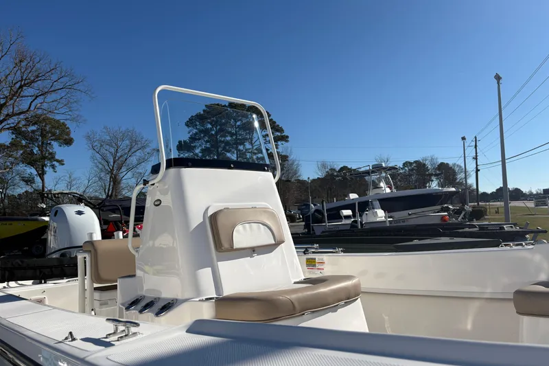 Slide: The Image of 2026 Sundance B20CCR boat with console and seating, displayed outdoors under clear blue sky. - 8