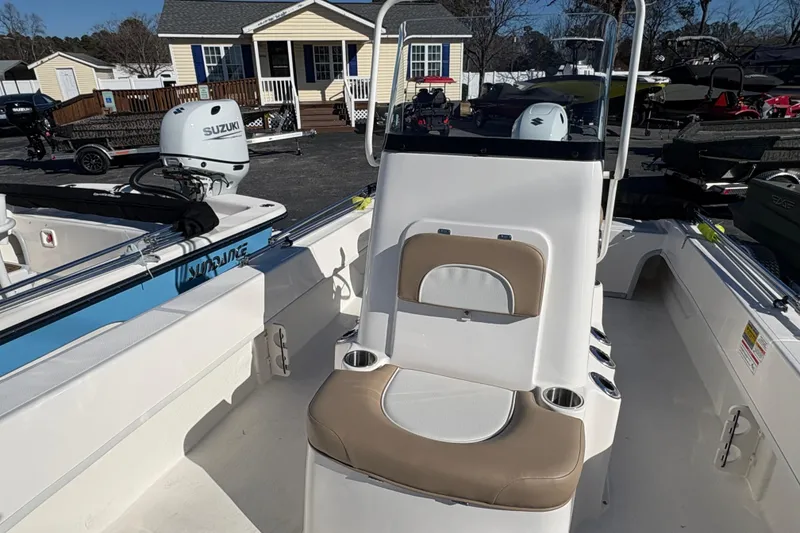 Slide: The Image of 2026 Sundance B20CCR boat with Suzuki outboard motor, displayed outdoors. - 9