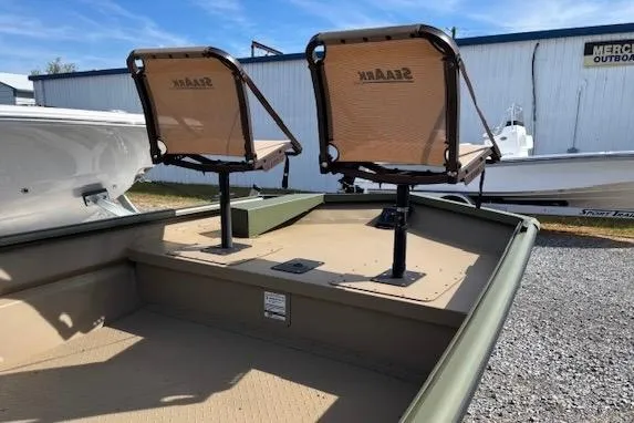 Slide: The Image of 2026 SeaArk 1860 MV boat with dual swivel seats, outdoor setting. - 3