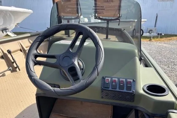 Slide: The Image of 2026 SeaArk 1860 MV boat dashboard with steering wheel and control panel. - 5