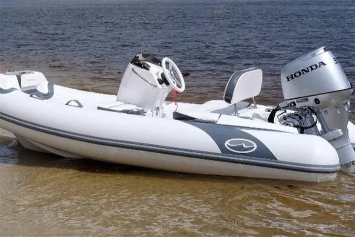 Slide: The Image of 2025 Walker Bay Generation 11 LTE boat with Yamaha 30HP engine on sandy shore. - 11