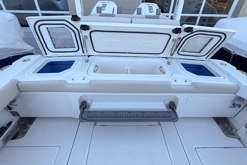Slide: The Image of Solace 32 CS 2026 boat with open storage and measuring scale. - 13