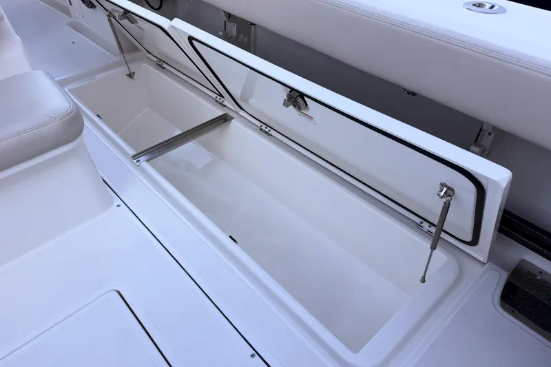 Slide: The Image of Open storage compartment in Solace 32 CS boat, year 2026. - 27