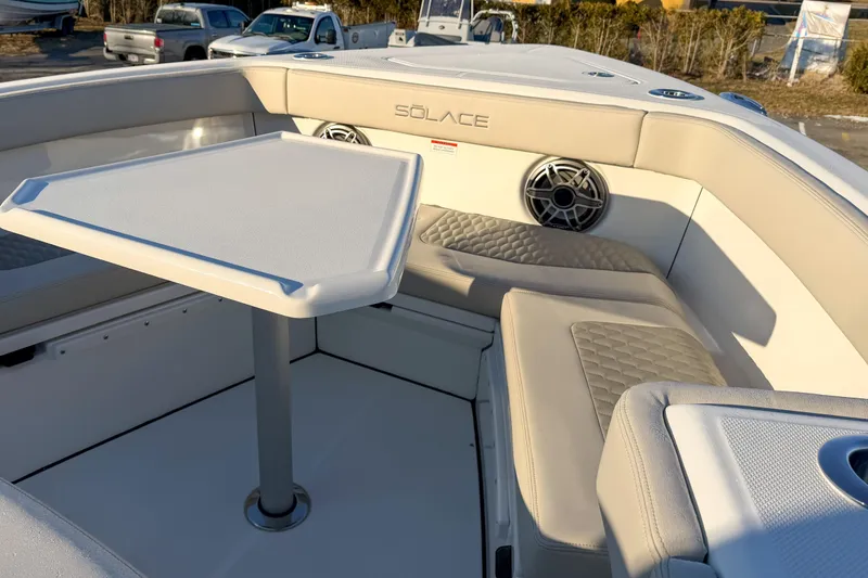 Slide: The Image of Interior of Solace 32 CS boat, 2026 model, featuring table and seating area. - 46