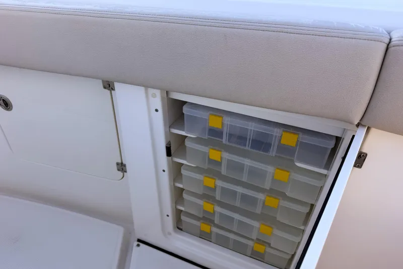 Slide: The Image of Solace 32 CS 2026 boat with built-in storage and plastic containers. - 49