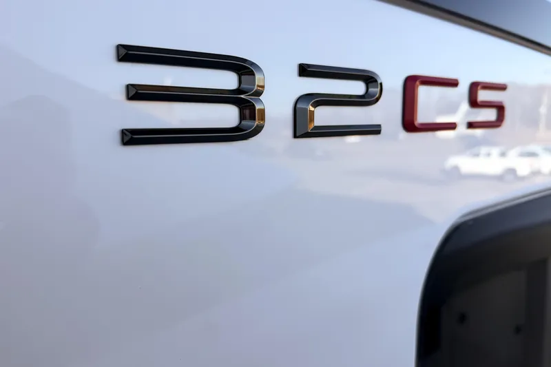 Slide: The Image of Close-up of Solace 32 CS emblem, model year 2026. - 7