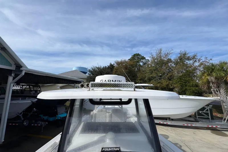 Slide: The Image of 2023 Fountain 38 Tournament Edition boat with Garmin equipment, parked outdoors. - 16