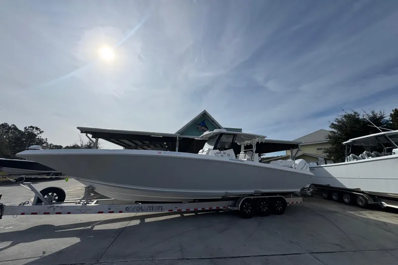 Slide: The Image of 2023 Fountain 38 Tournament Edition boat on trailer under sunny sky. - 2