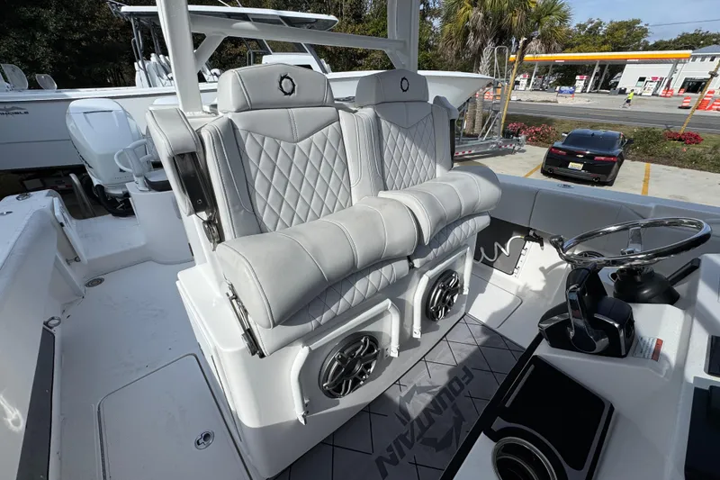 Slide: The Image of 2023 Fountain 38 Tournament Edition boat interior with luxury seating and steering wheel. - 27