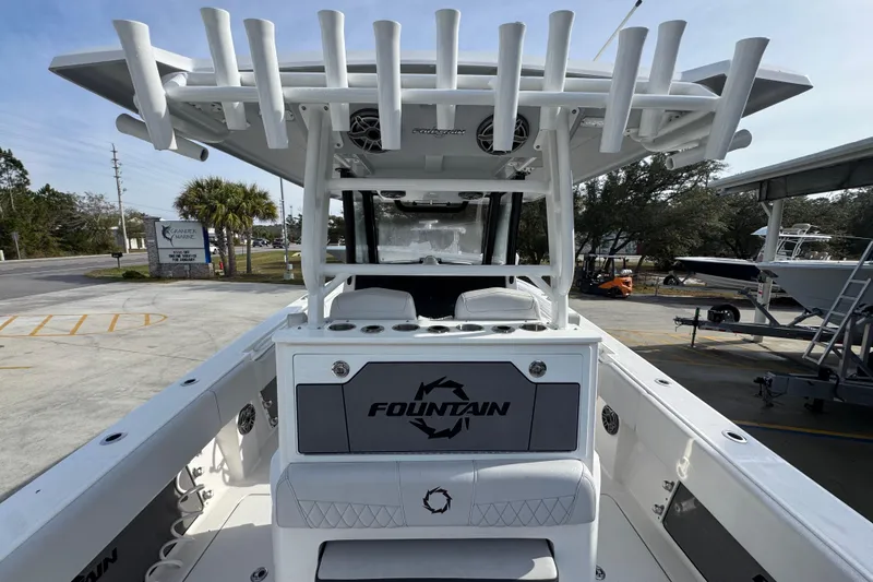 Slide: The Image of 2023 Fountain 38 Tournament Edition boat with rod holders and seating, parked outdoors. - 28