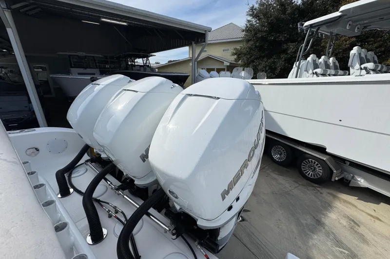 Slide: The Image of 2023 Fountain 38 Tournament Edition with triple Mercury outboard engines in a boatyard. - 33