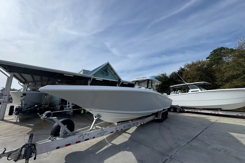 Slide: The Image of 2023 Fountain 38 Tournament Edition boat on trailer, parked outdoors under clear sky. - 4