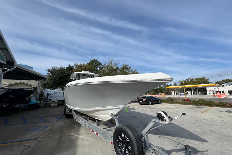 Slide: The Image of 2023 Fountain 38 Tournament Edition boat on trailer, parked outdoors under blue sky. - 6